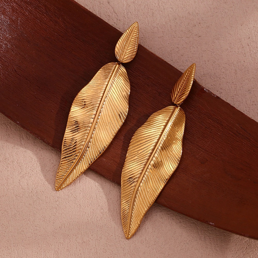 Gold spliced feather leaf earrings of different sizes