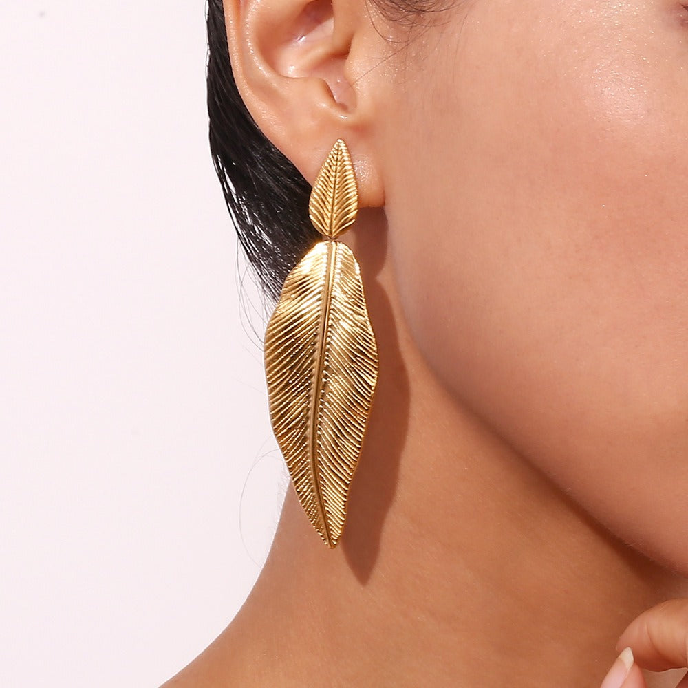 Gold spliced feather leaf earrings of different sizes